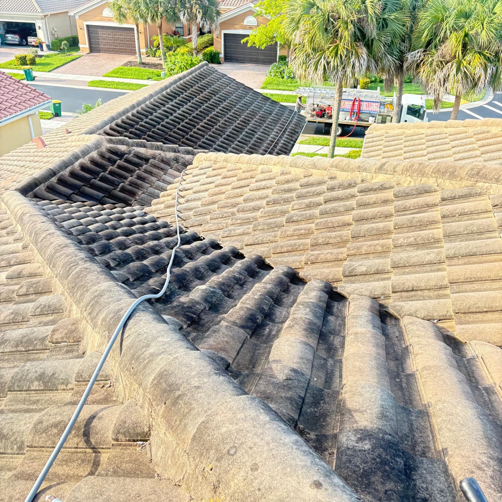 Heavily stained tile roof before cleaning — HOA community SW Florida